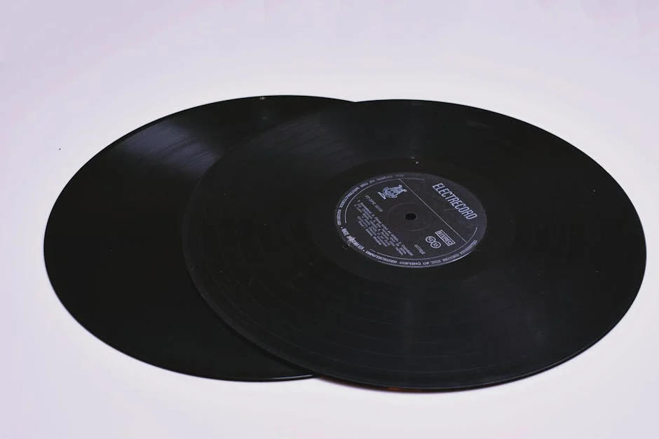 Close-up of two classic vinyl records on a flat surface, showcasing grooves.
