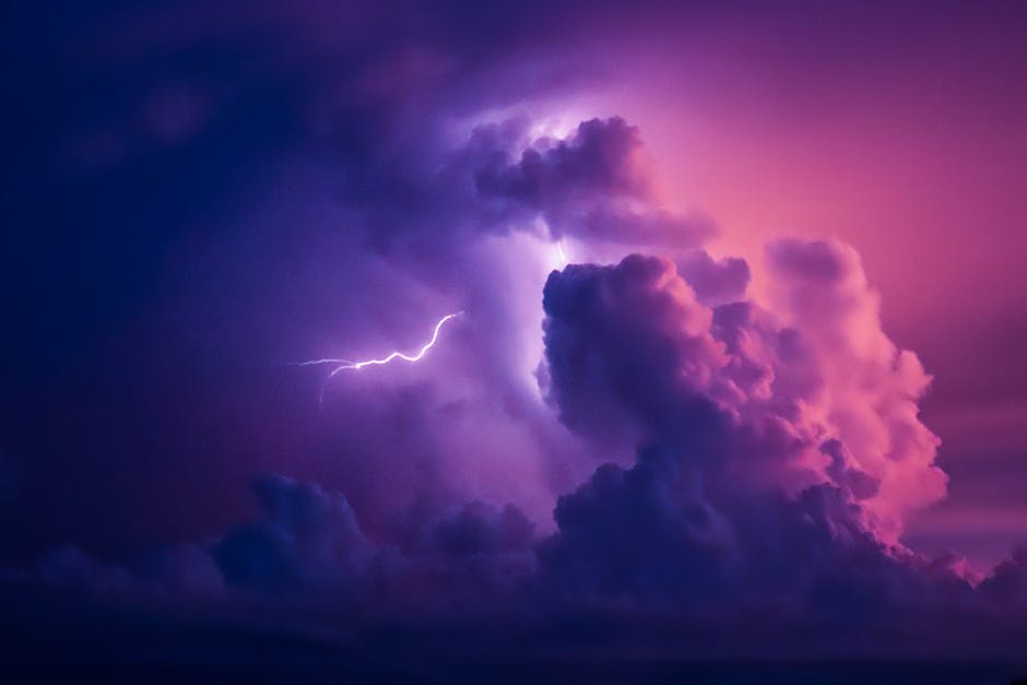 A striking image of lightning illuminating dramatic purple clouds in the night sky.