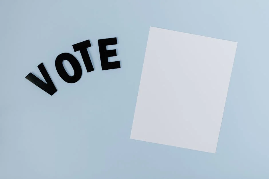 Flat lay of blank paper with 'VOTE' letters on light blue background, ideal for election-themed content.